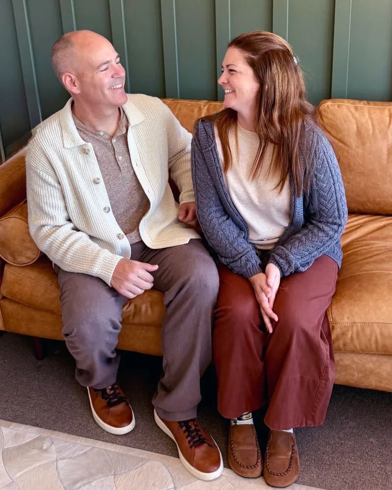 Ryan and Jennie Denney sitting together in their office